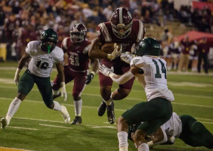 Picayune running back Dante Dowdell (2) jumps through West Point's Chris Chandler (14) and into the end zone for a touchdown during the first quarter of the MHSAA Class 5A football championship game.
